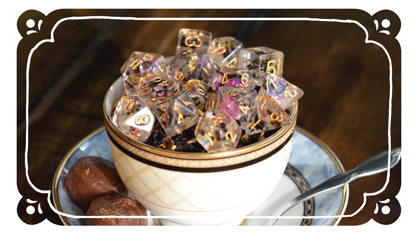 A teacup filled with tea leaves and floral dice
