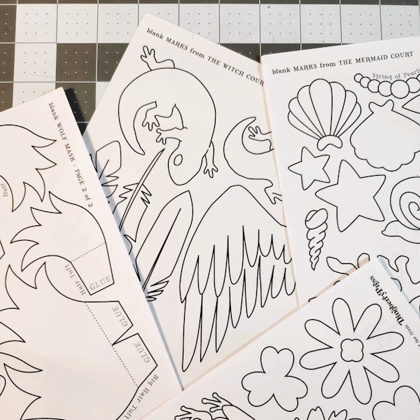 A photo of print-color-and-cut templates of marks to decorate masks with.